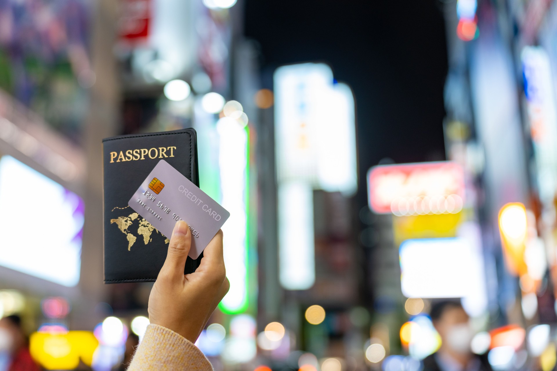 Asian woman showing passport and credit card during shopping at Shibuya district, Tokyo city, Japan